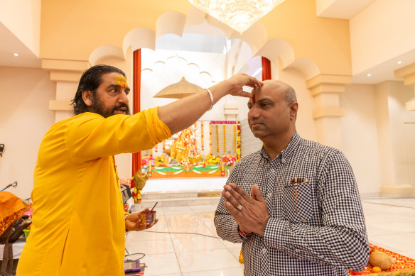 Gurpreet Verma (right) with a Hindu priest at the Sri Durga temple in Rockbank.