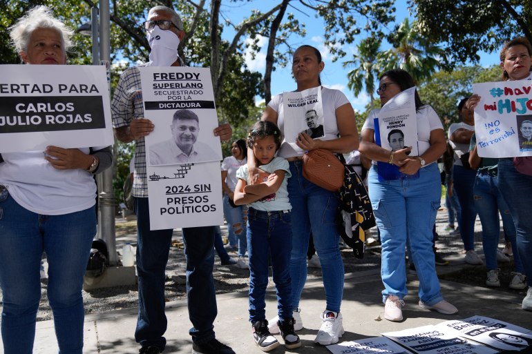 A line of people protest against political prisoners being held in Venezuela