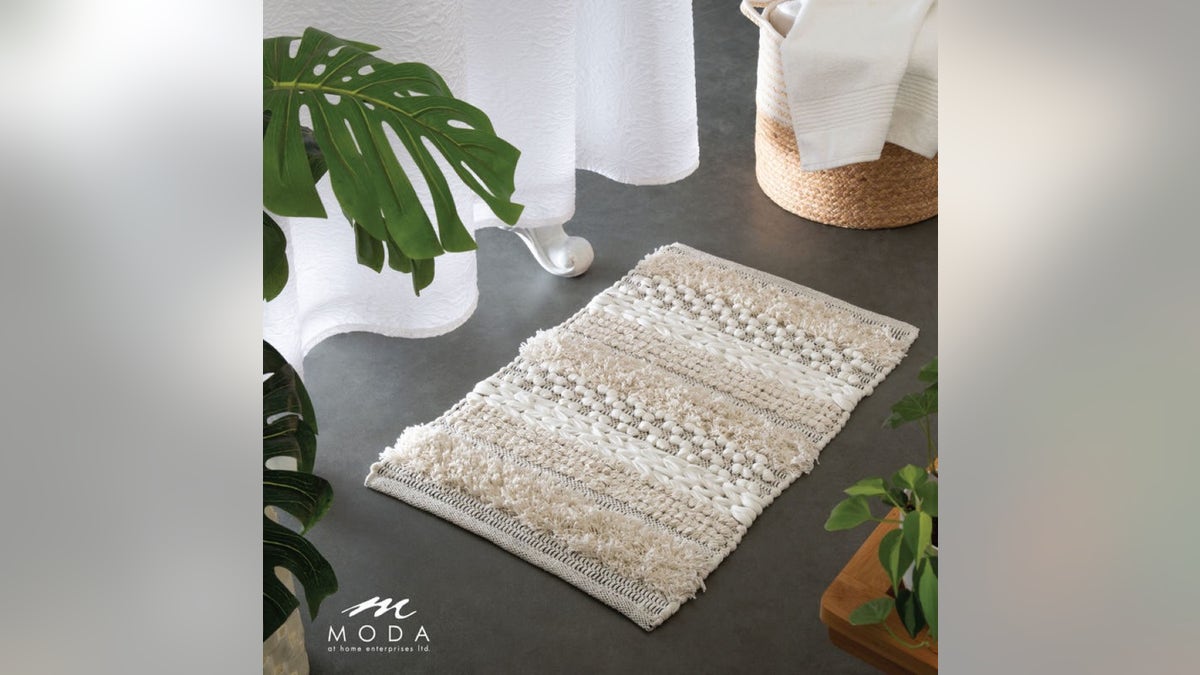 A knitted bath mat adds a cozy, handcrafted touch to your bathroom space. 