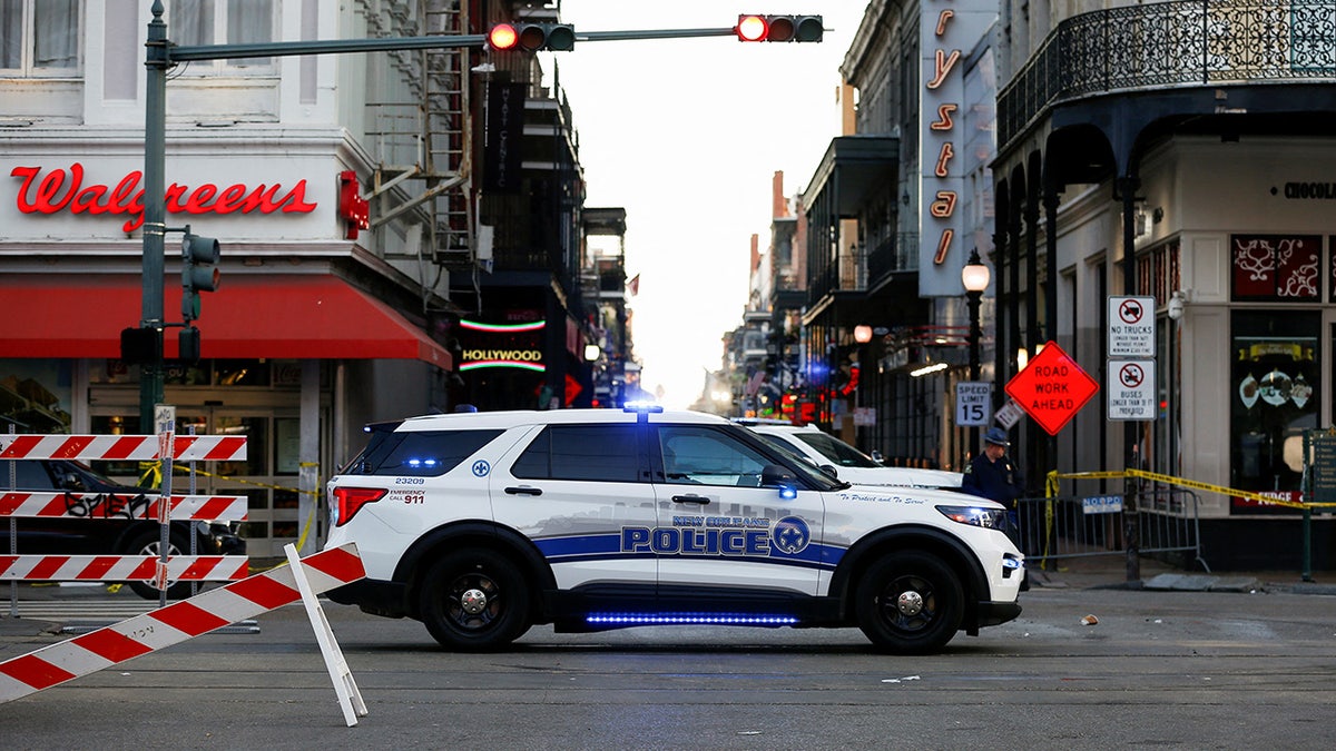 A New Orleans police vehicle blocks the entrance to Bourbon Street