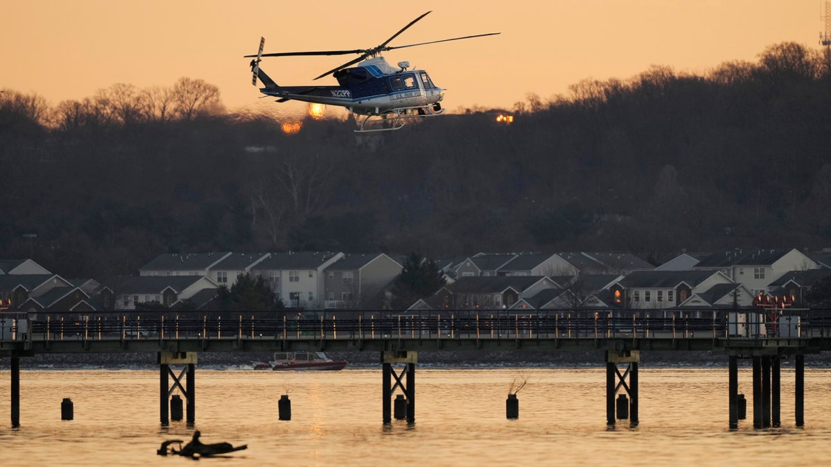 A US Park Police helicopter flies over the Potomac River