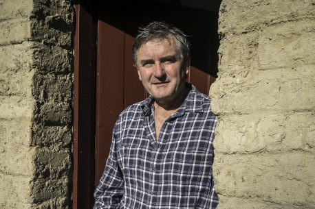 Richard Glover at the door of his mud brick house he built over many decades.