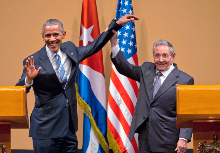 Barack Obama poses with Raul Castro