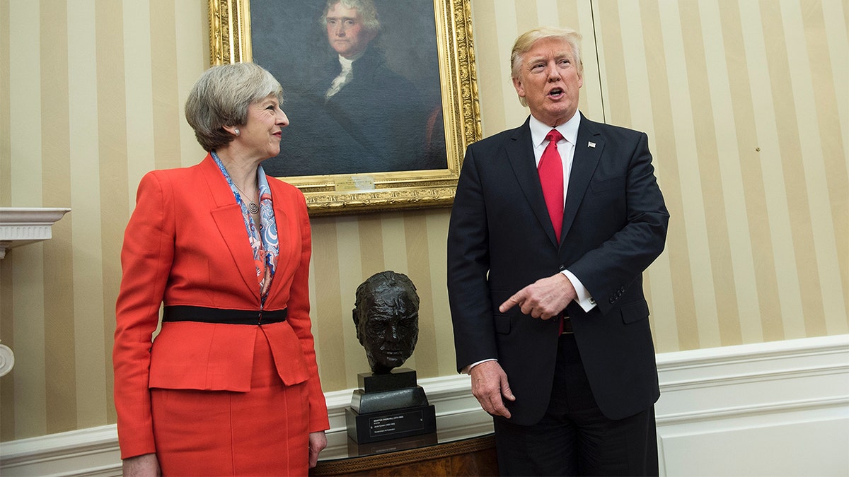 British Prime Minister Theresa May and President Donald Trump pose by Winston Churchill bust in Oval Office