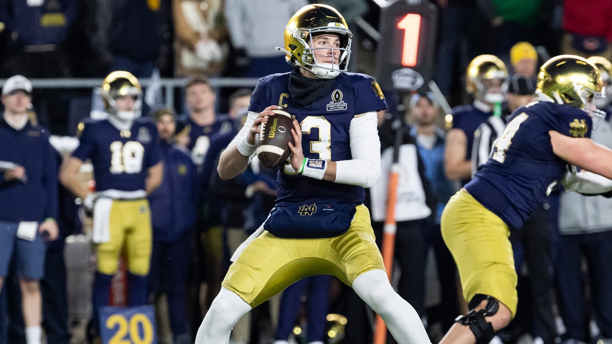 Notre Dame quarterback Riley Leonard drops back to pass against Indiana in a home playoff game.