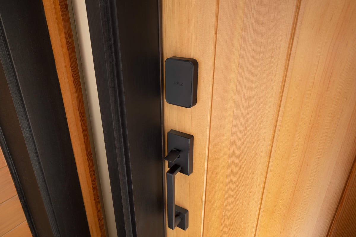 The Schlage Sense Pro lock installed on a light wood door.