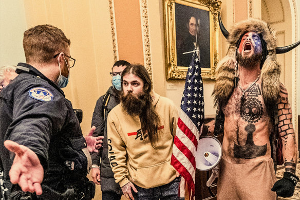 Jacob Chansley (right), known as the Qanon Shaman, in the Capitol building during the January 6 insurrection, where the intersection between conspiracy theories and violence was on display.