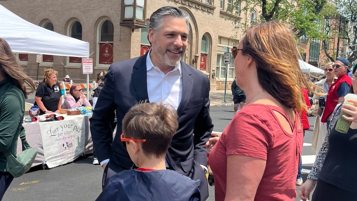 Republican gubernatorial candidate Bill Spadea talks with voters at a street fair in Somerville, N.J., on June 1, 2025.