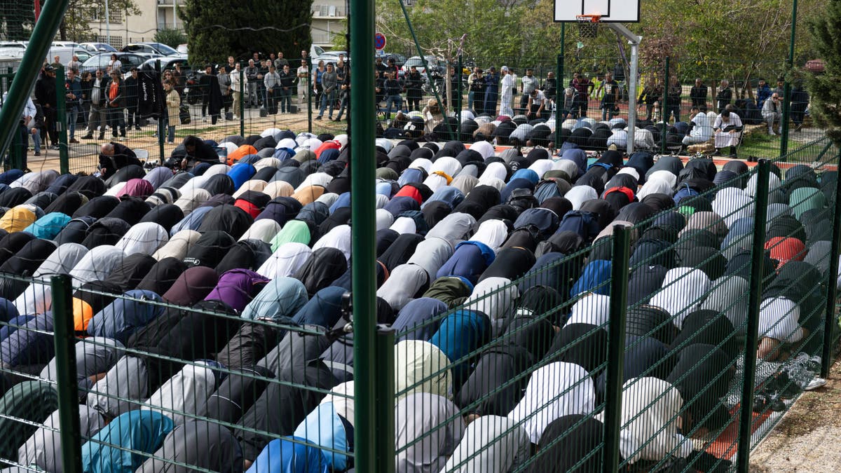 Some French Muslims criticized the report on the Muslim Brotherhood. An unrelated photo shows Muslim men praying in Marseille, France.