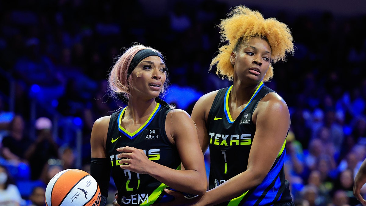 DiJonai Carrington and NaLyssa Smith on court