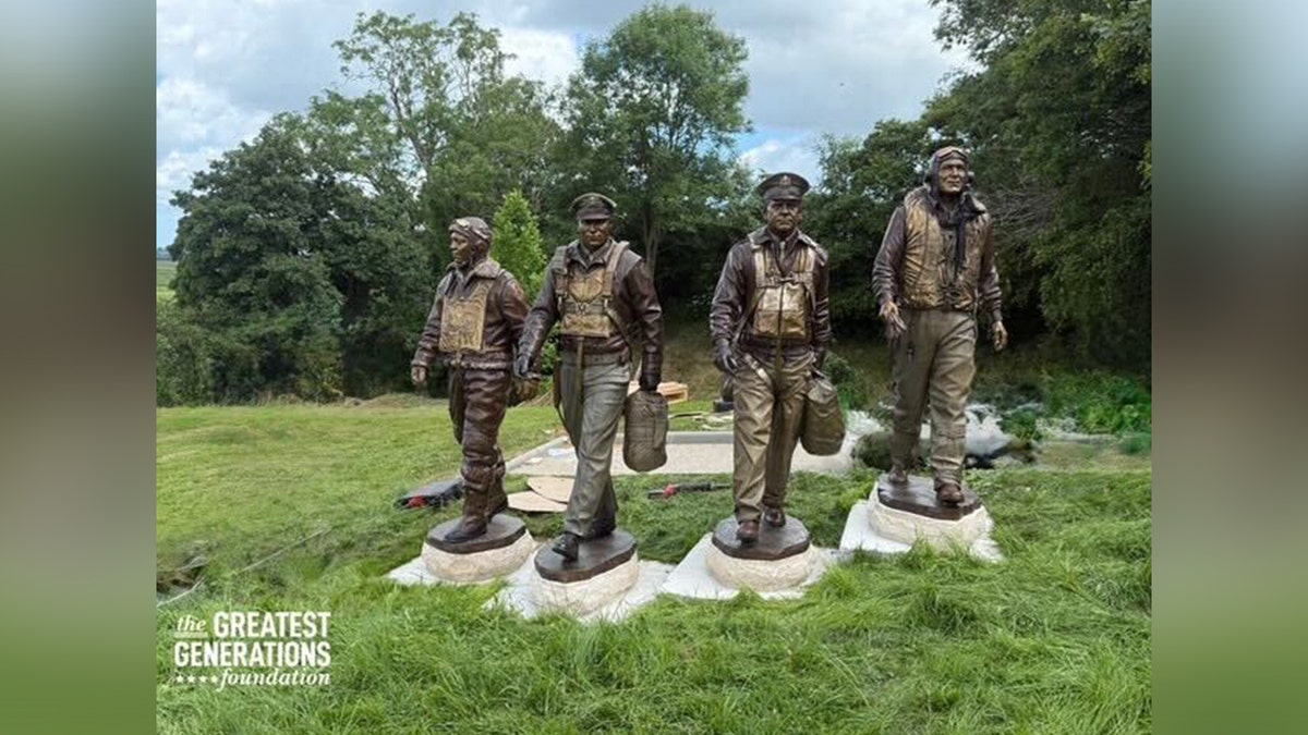 Statues of World War II veterans on grass