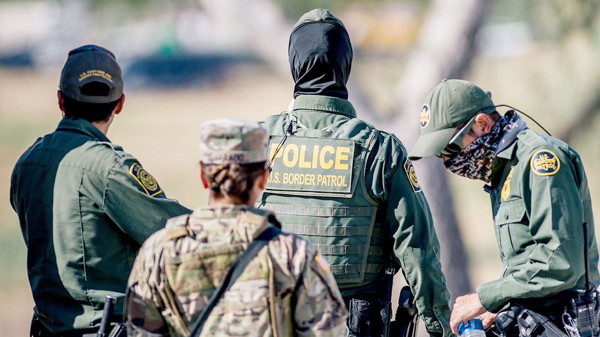 border agents seen from behind