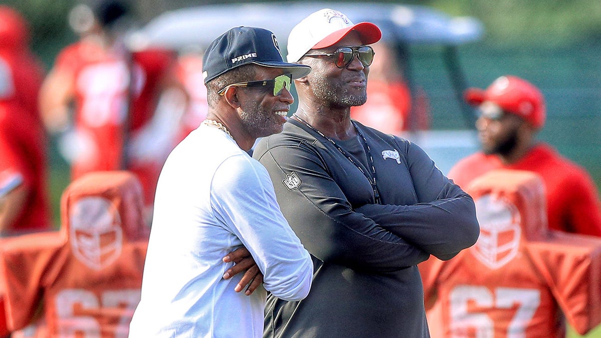 Deion Sanders and Todd Bowles smiles on field