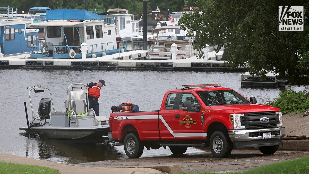Members of the La Crosse Fire Department searching in the Mississippi River