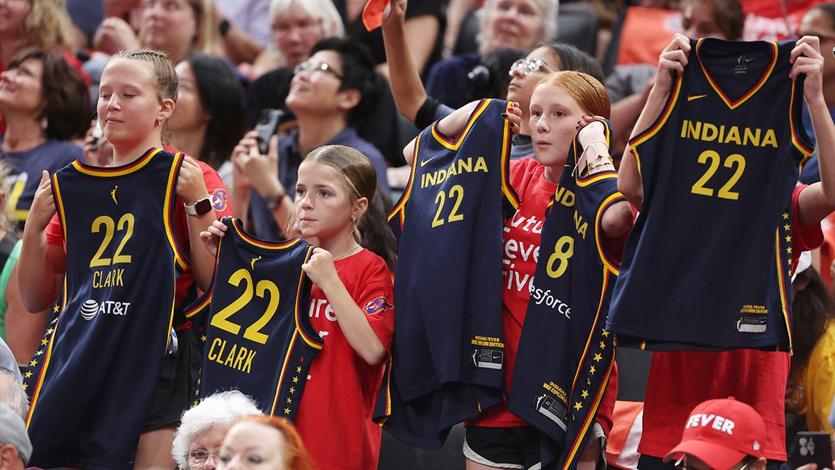 Fever fans hold up jerseys