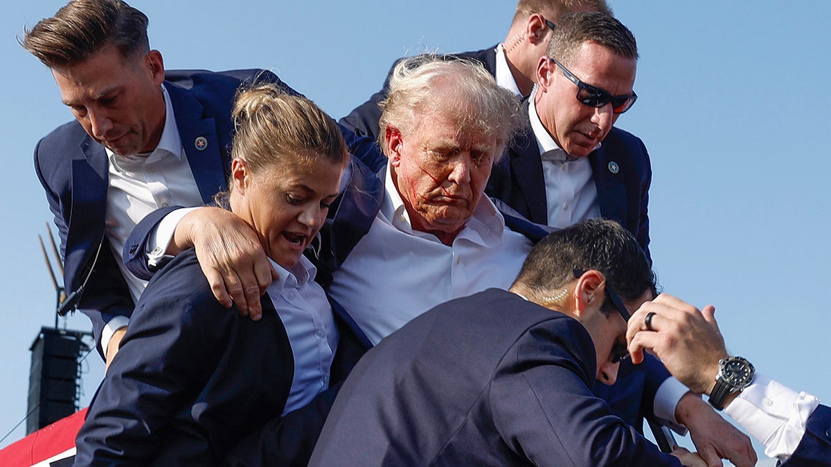 Donald Trump is rushed offstage by U.S. Secret Service agents