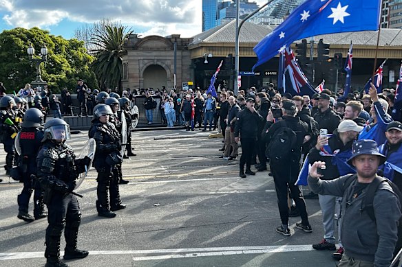 National Socialist Network and other anti-immigration protesters confront a line of riot police on St Kilda Road.