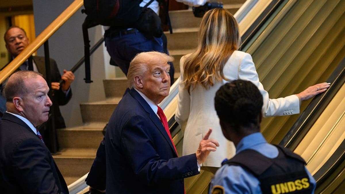 Donald Trump rides an escalator at the United Nations