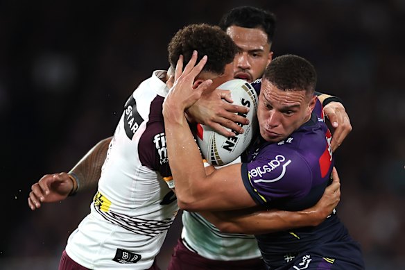Will Warbrick of the Storm is tackled during the NRL grand final against Brisbane.