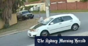 Passenger caught on camera riding on car bonnet