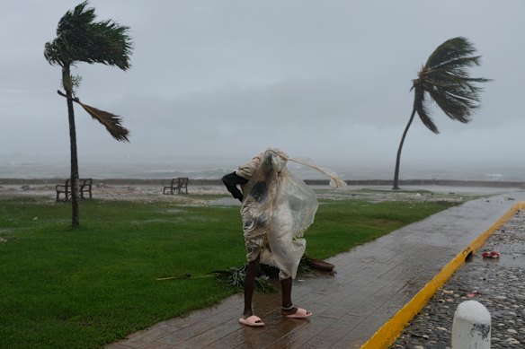A man walks in Kingston, Jamaica, as Hurricane Melissa approaches.