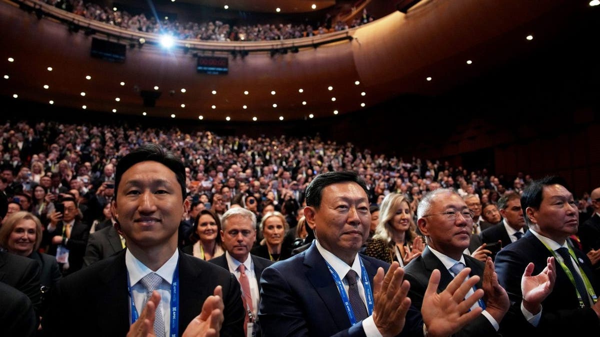 Attendees applaud as U.S. President Donald Trump