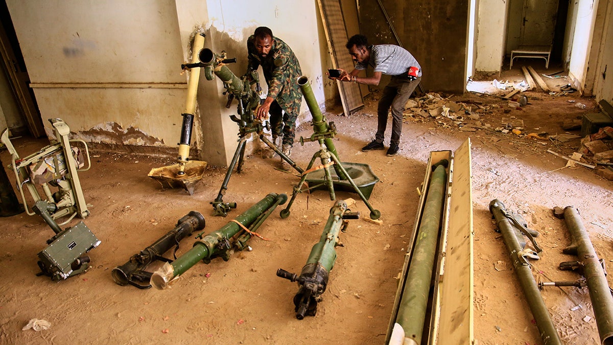 FILE - Sudanese army officers inspect a recently discovered weapons storage site belonging to the paramilitary Rapid Support Forces (RSF) in Khartoum, Sudan, Saturday, May 3, 2025.