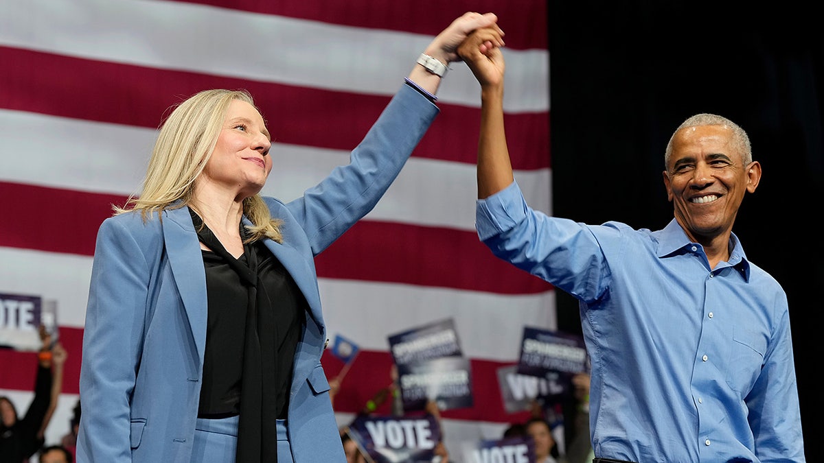Virginia Democratic gubernatorial candidate Abigail Spanberger joins former President Barack Obama, during a campaign event Saturday, Nov. 1, 2025, in Norfolk, Va. (AP Photo/Steve Helber)