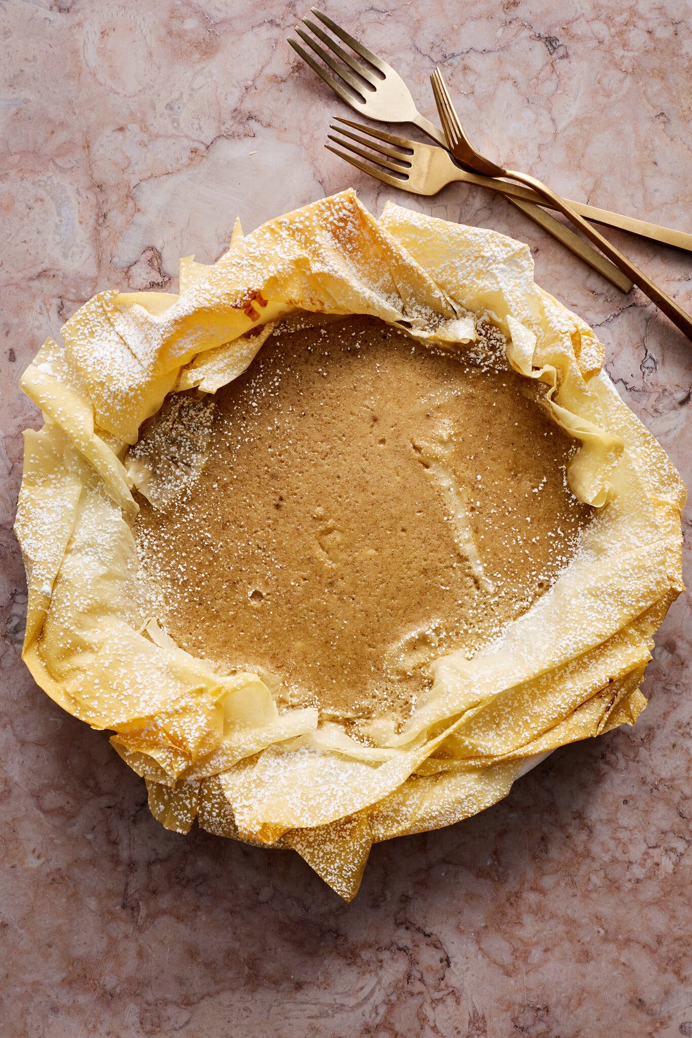 An overhead image of a banana pie with a phyllo crust.