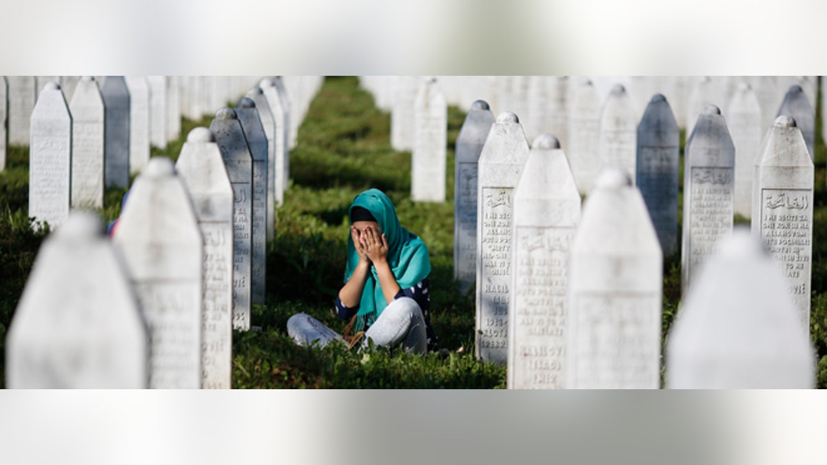 July 11, 2015: A woman mourns among graves in Memorial Center Potocari, near Srebrenica, Bosnia and Herzegovina.
