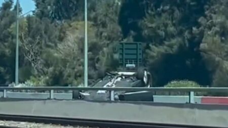 Allegedly stolen car ends on roof on Kwinana Freeway