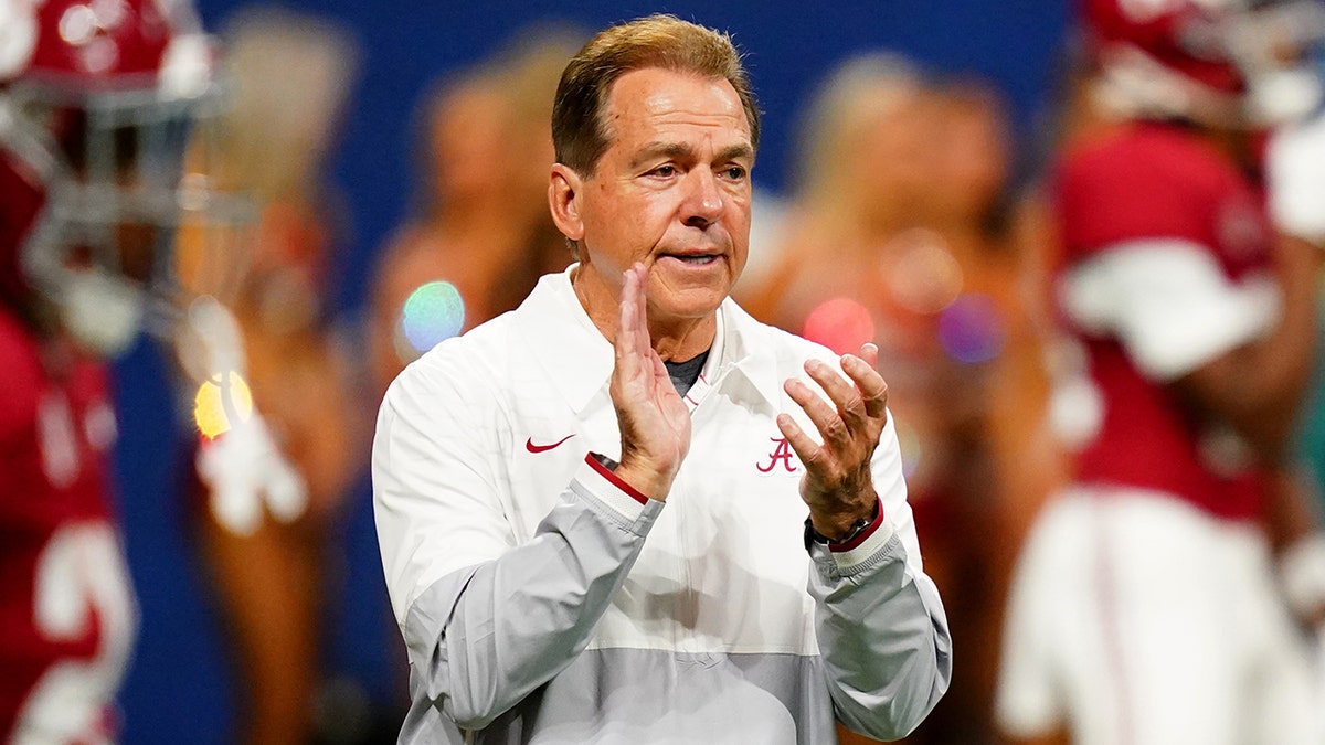 Nick Saban claps on the sideline