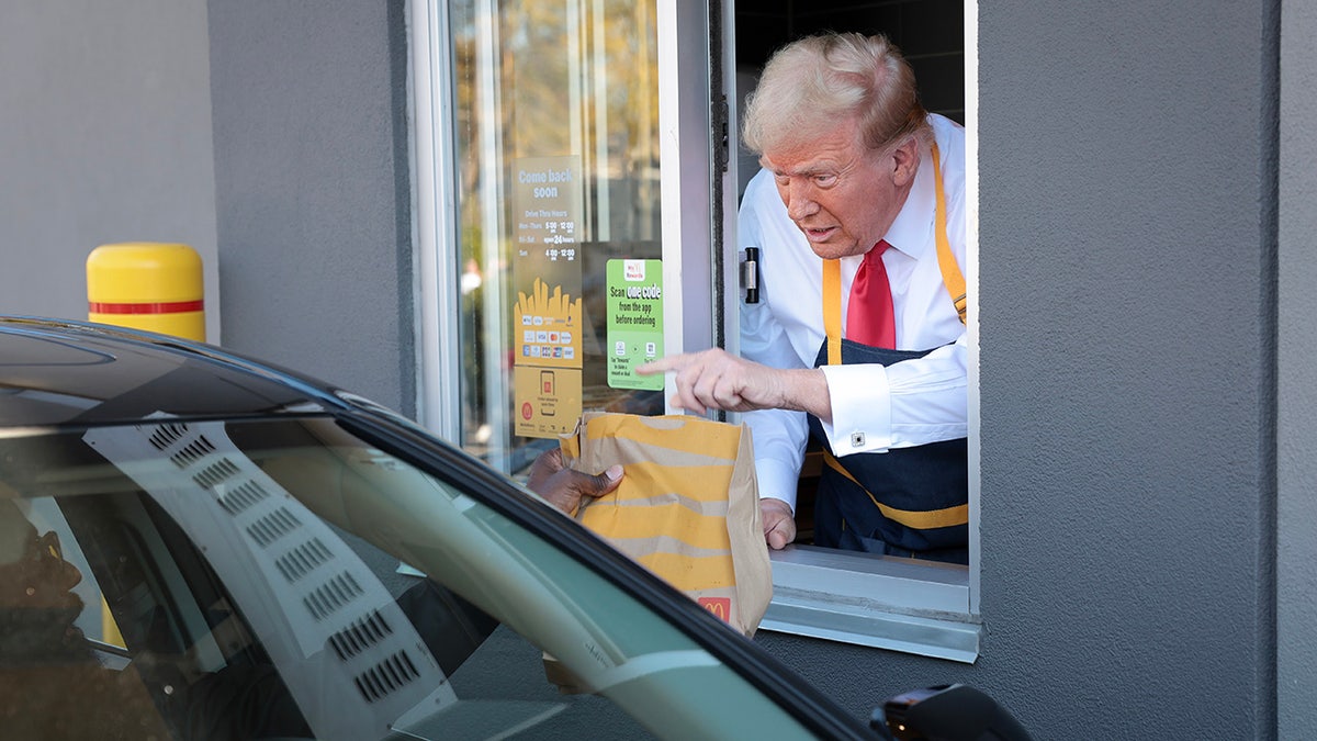 Donald Trump handing a customer their meal at McDonald's.
