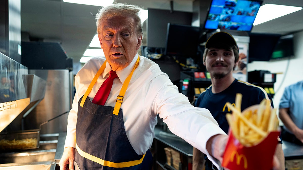 Donald Trump works behind the counter during a campaign event at McDonald's restaurant.