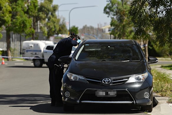 A NSW police forensic officer inspects the car which had Victorian number plates.