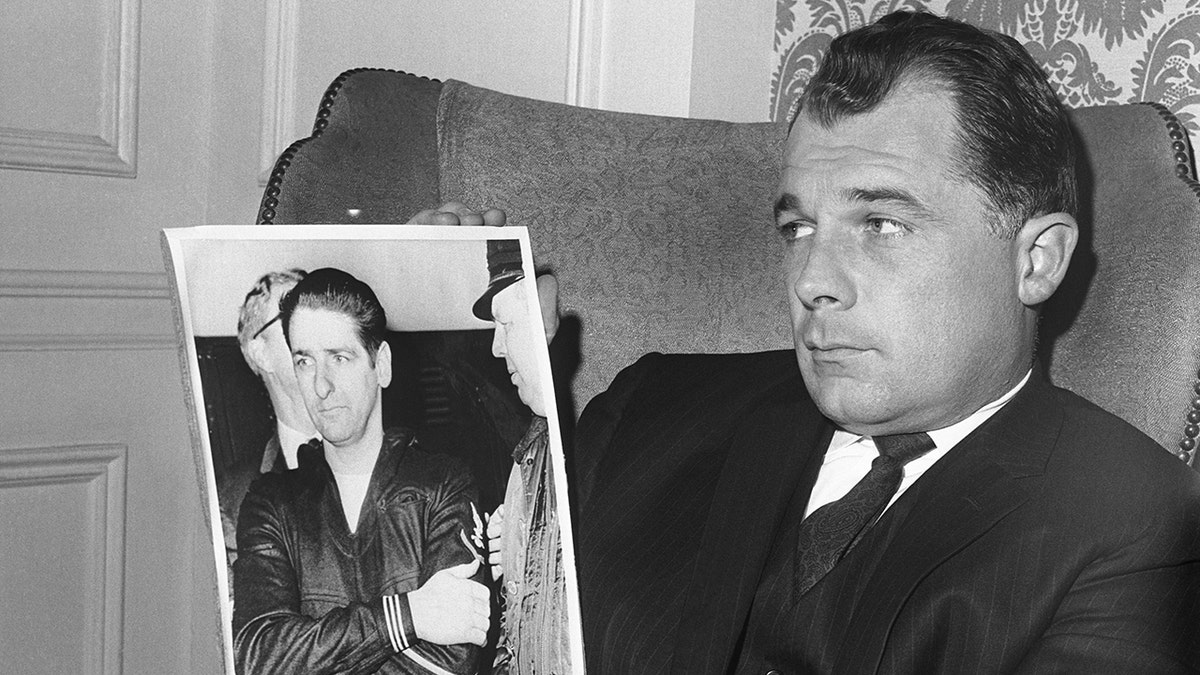 F. Lee Bailey holding a photo of Albert DeSalvo.