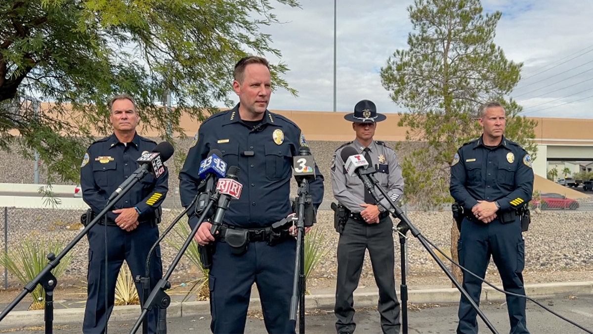 Henderson Police Chief Reggie Rader and other officers speak to media