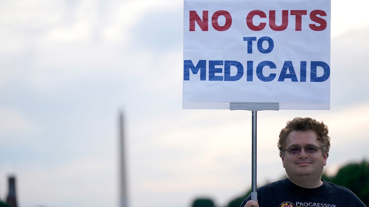 Protester holds sign rallying against Republicans