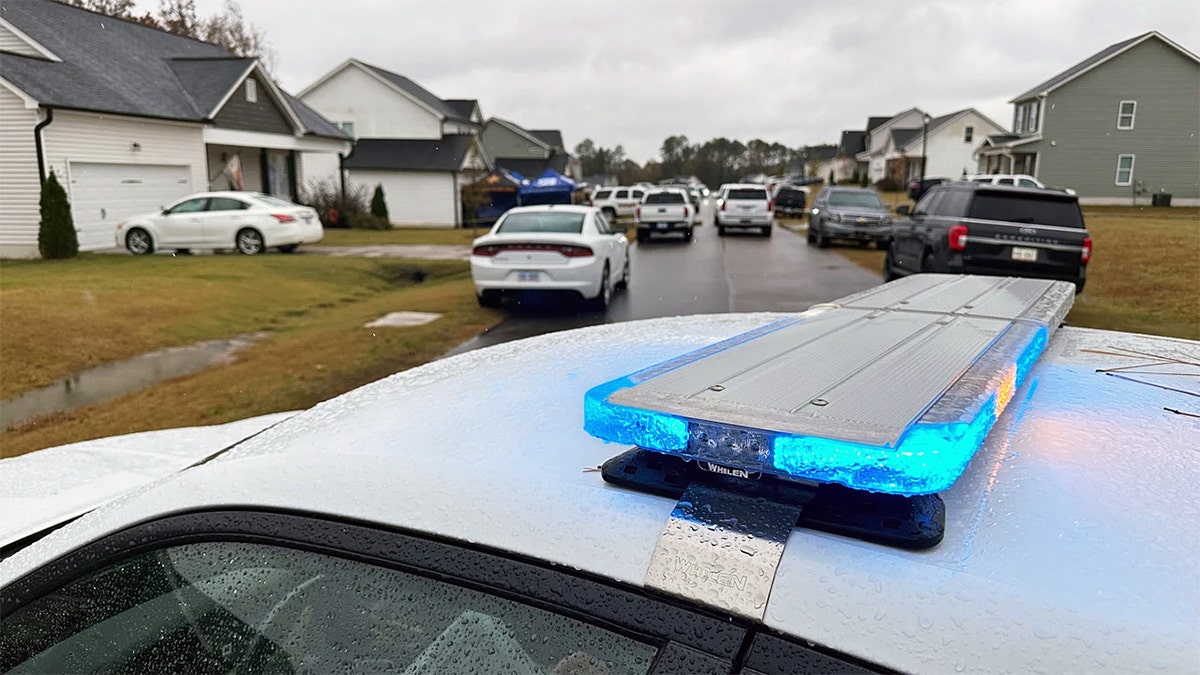 Law enforcement vehicles by Wellington Dickens III's home in North Carolina