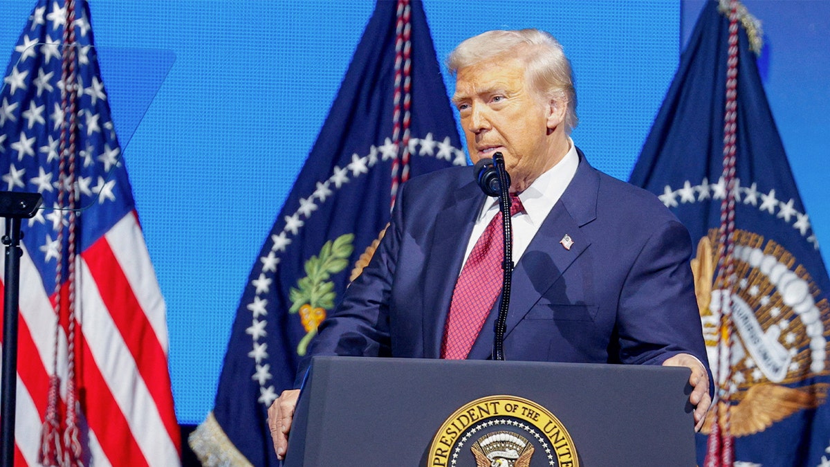 President Donald Trump standing in front of a microphone