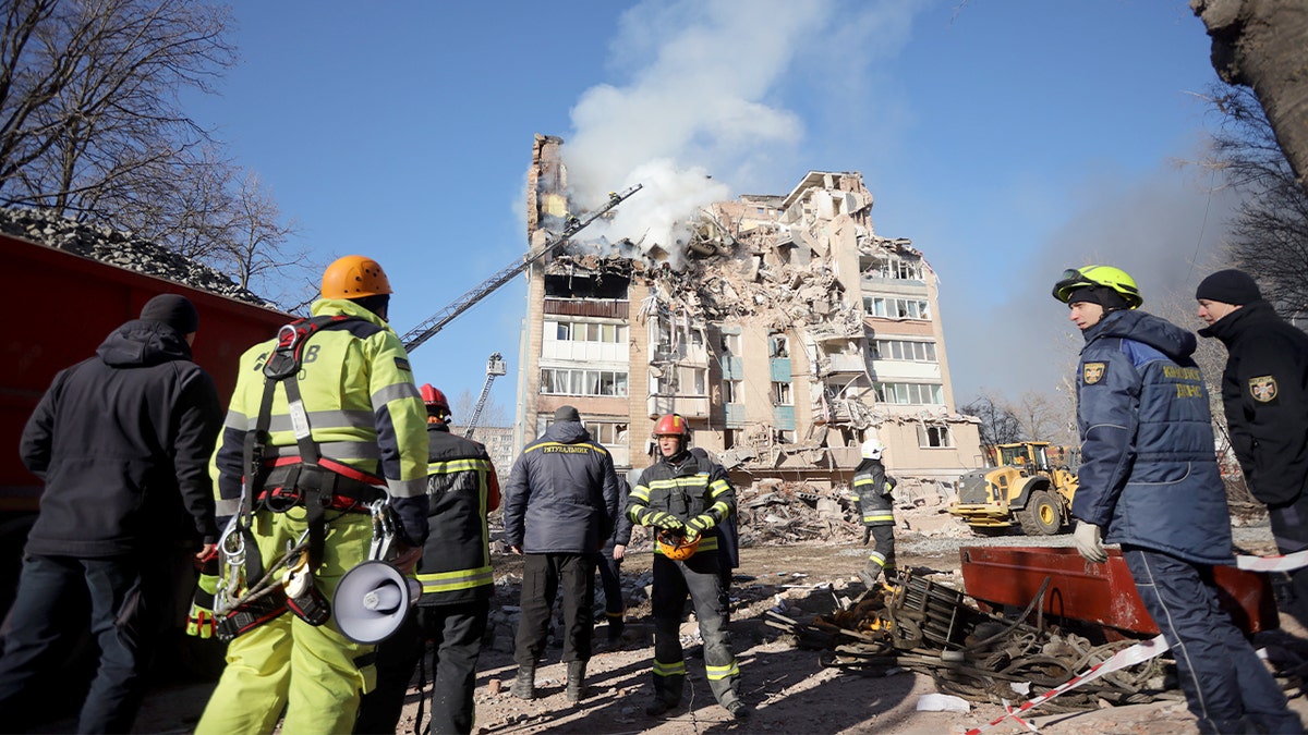 Firefighters extinguish flames in a damaged apartment building after an airstrike in western Ukraine.