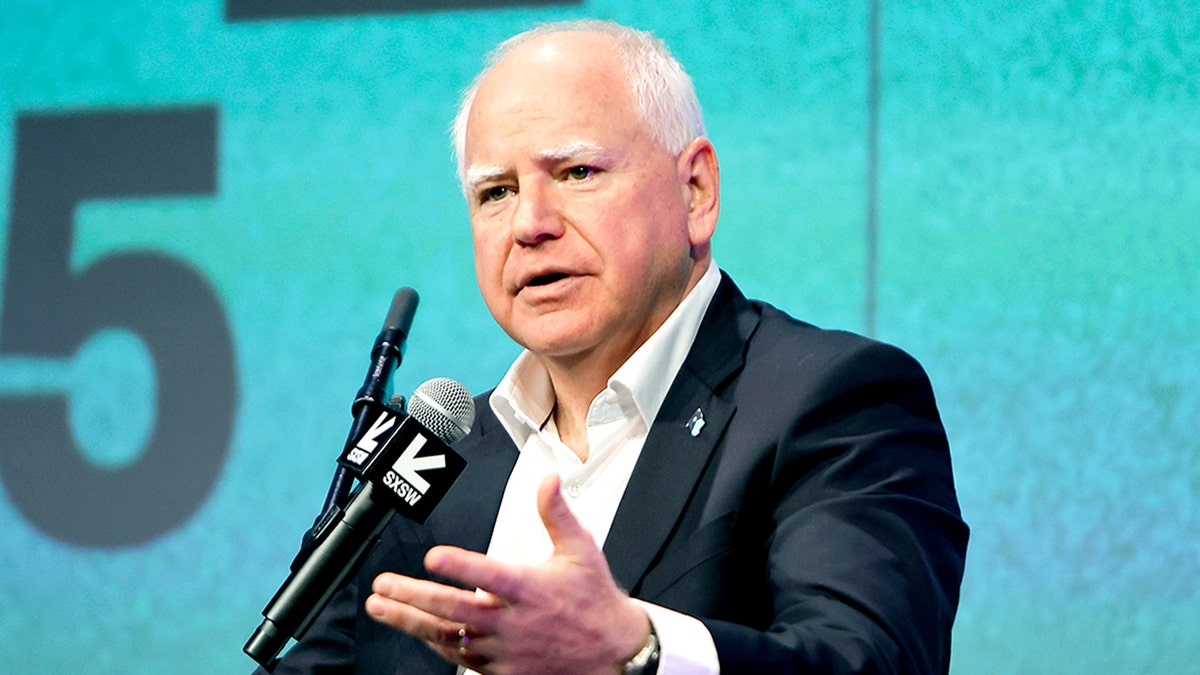 Minnesota Gov. Tim Walz speaking into a microphone.