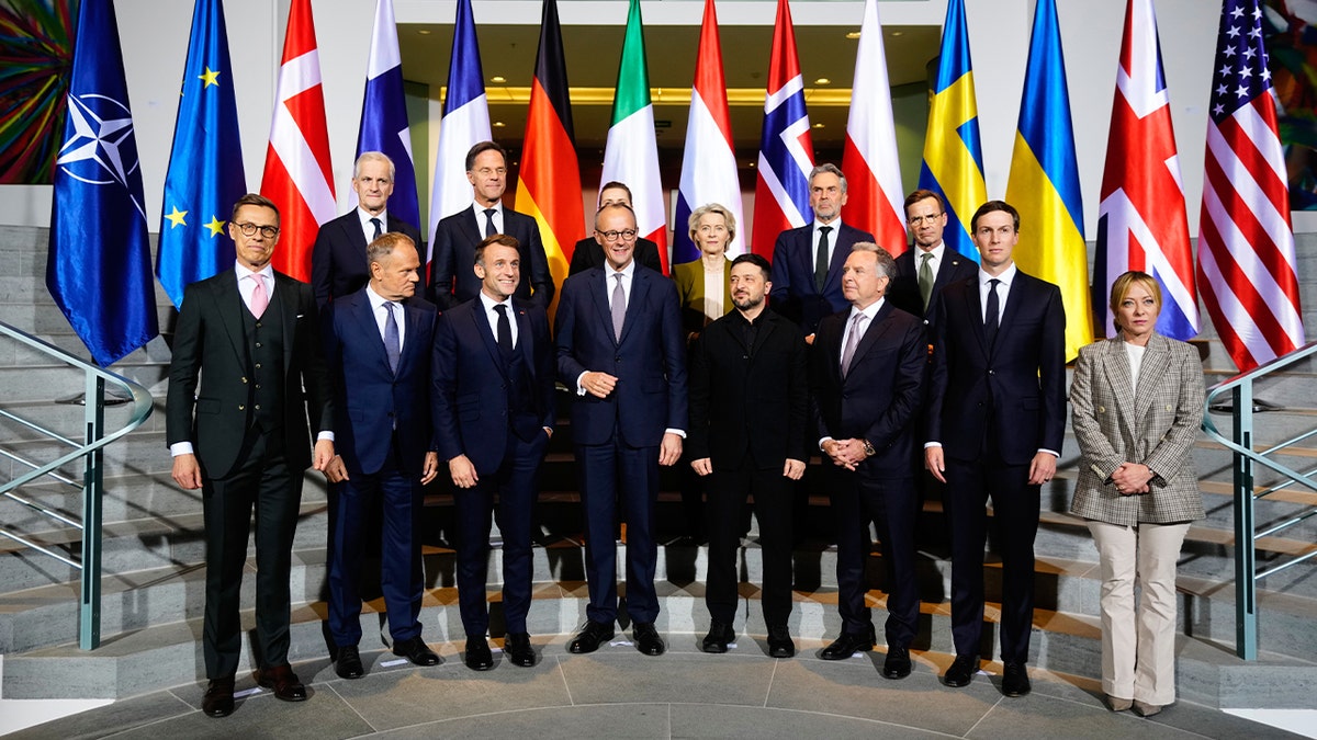A group of European and international leaders pose for a formal photo during a high-level meeting in Berlin.