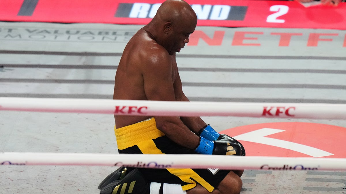 Anderson Silva kneels in the ring