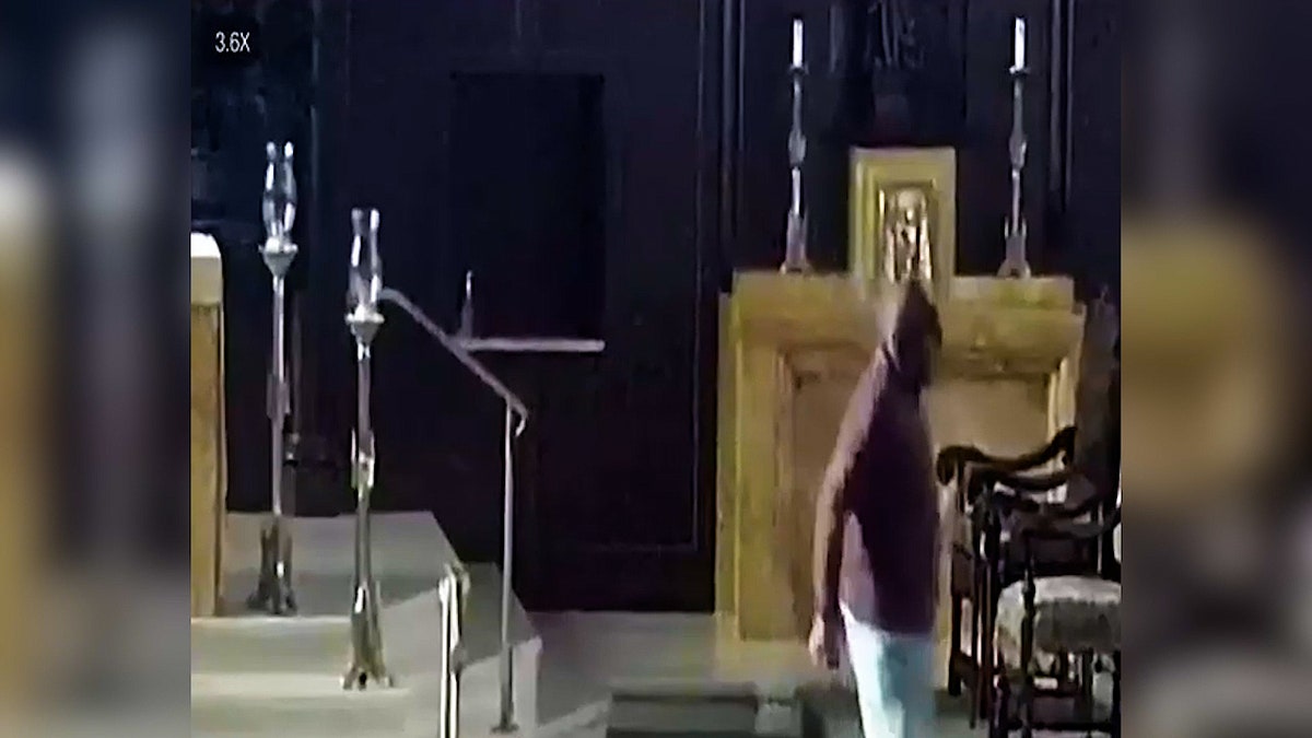 Suspect leaving the worship area of a church.