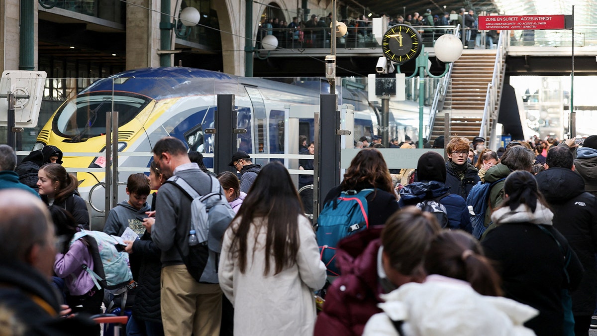 Passengers wait in front of a train in Pairs