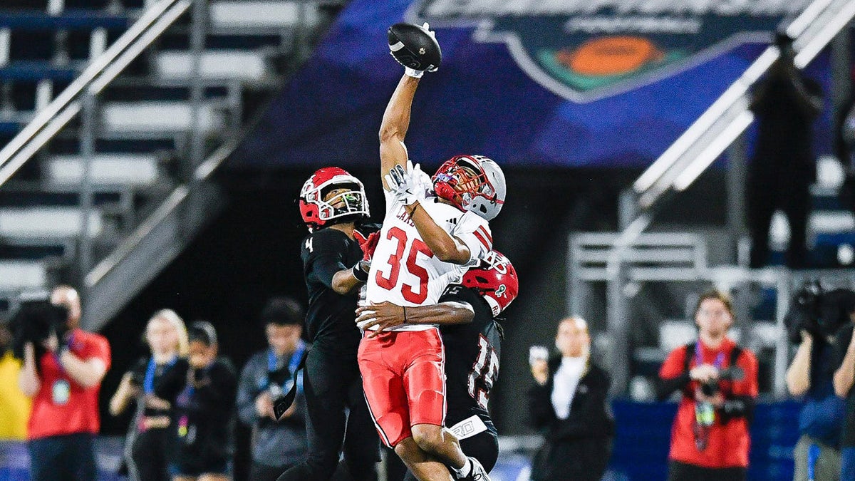 A high school football player makes a catch