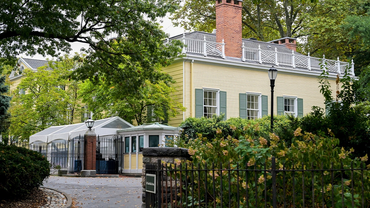 yellow mansion building with trees