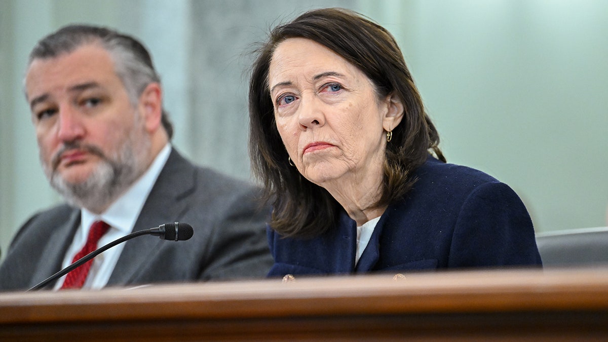 Maria Cantwell looks on