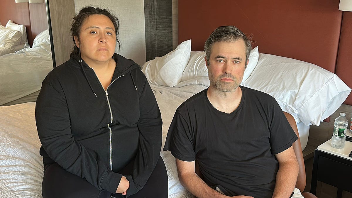 Rutgers professor Mark Bray and wife wearing black in hotel room